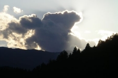 The sun behind the clouds over Triglav